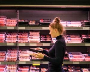A woman buying meat at the grocery store