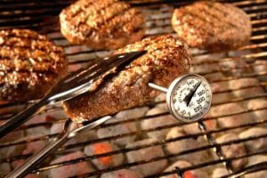 meat thermometer checking grilled meat