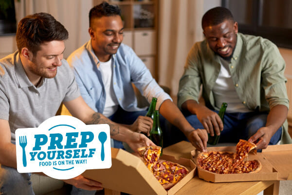 A group of men enjoying a pizza