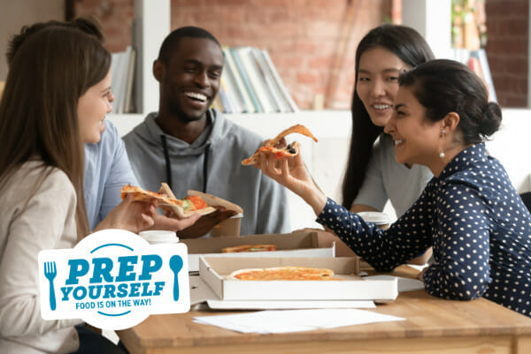 A group enjoying a pizza