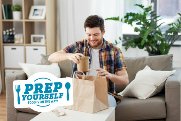 A man unpacking bag of food delivery